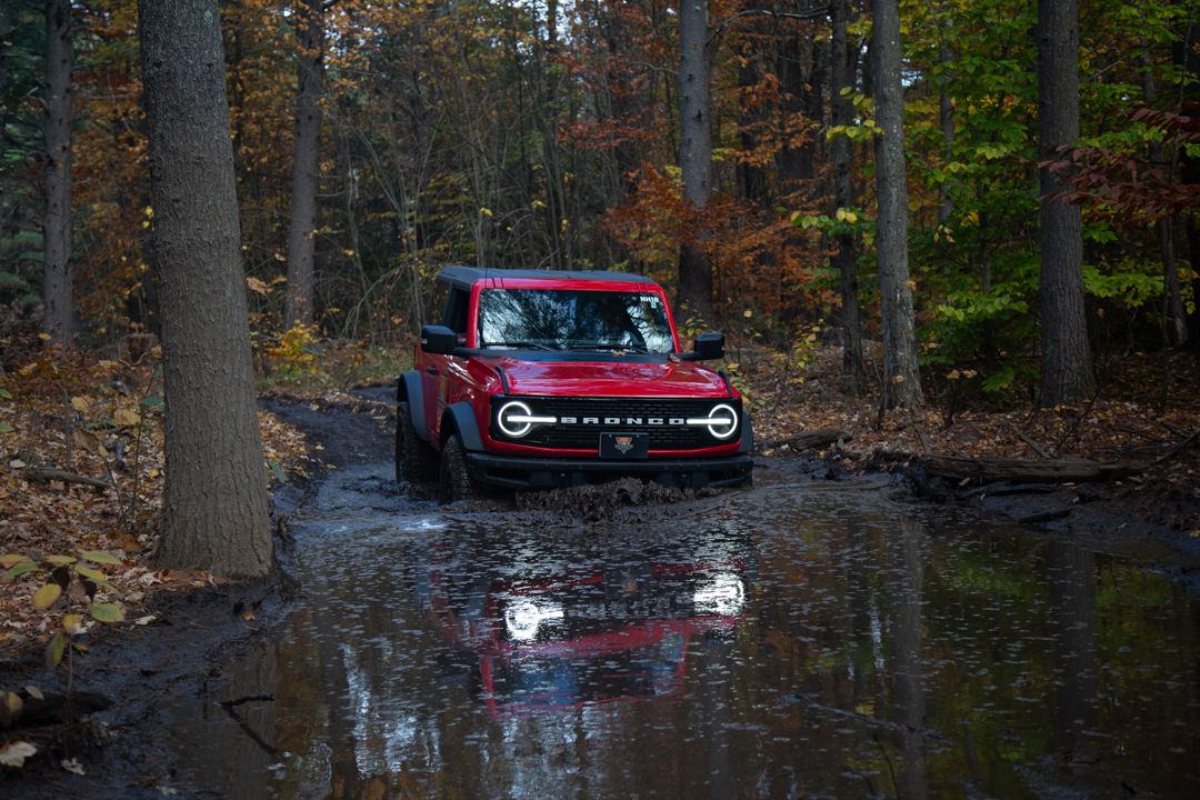 bronco driving through mud
