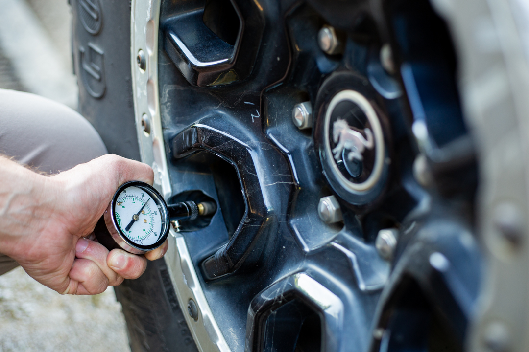 man checking tire pressure