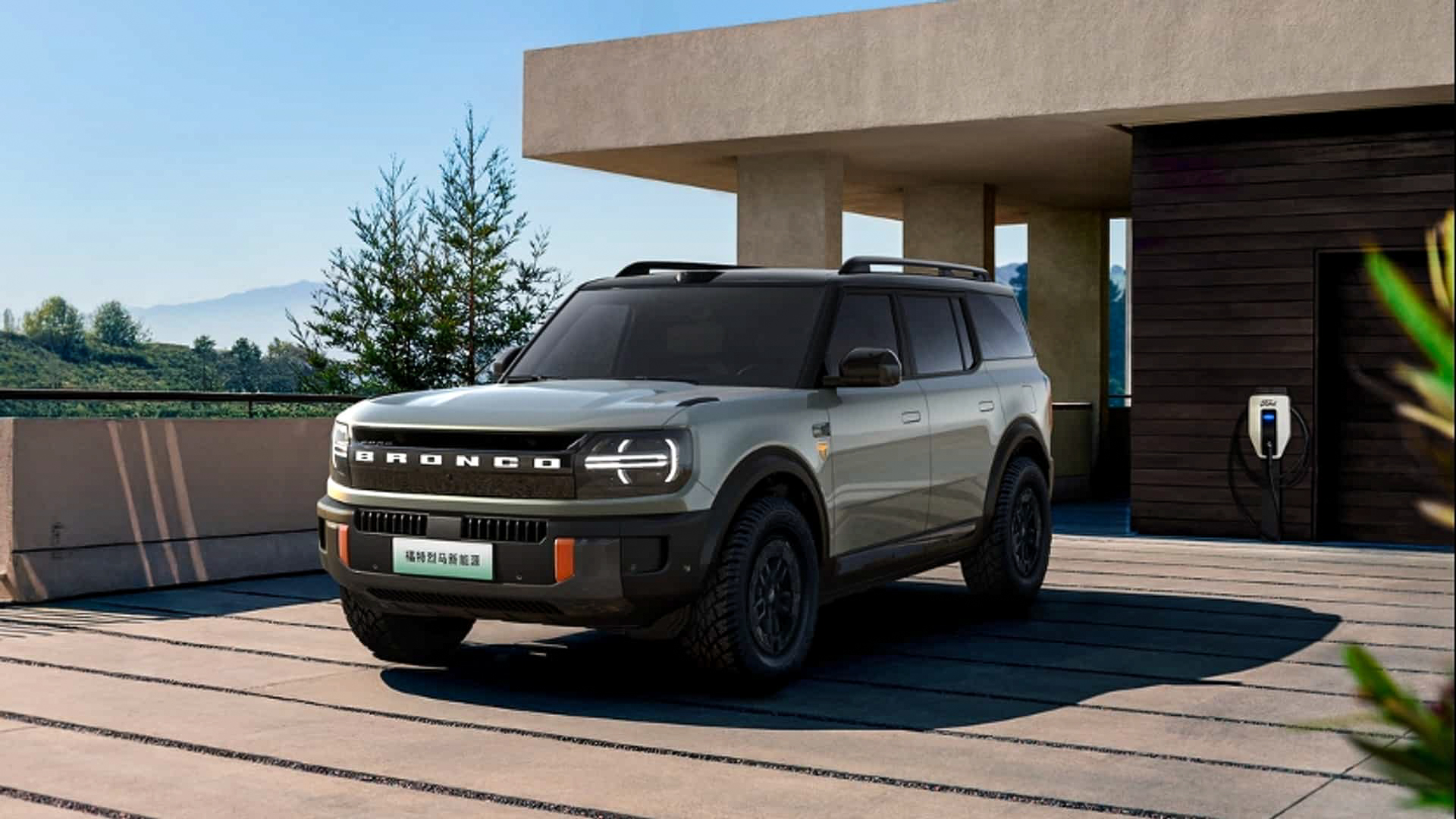 ford bronco ev outside by charging station
