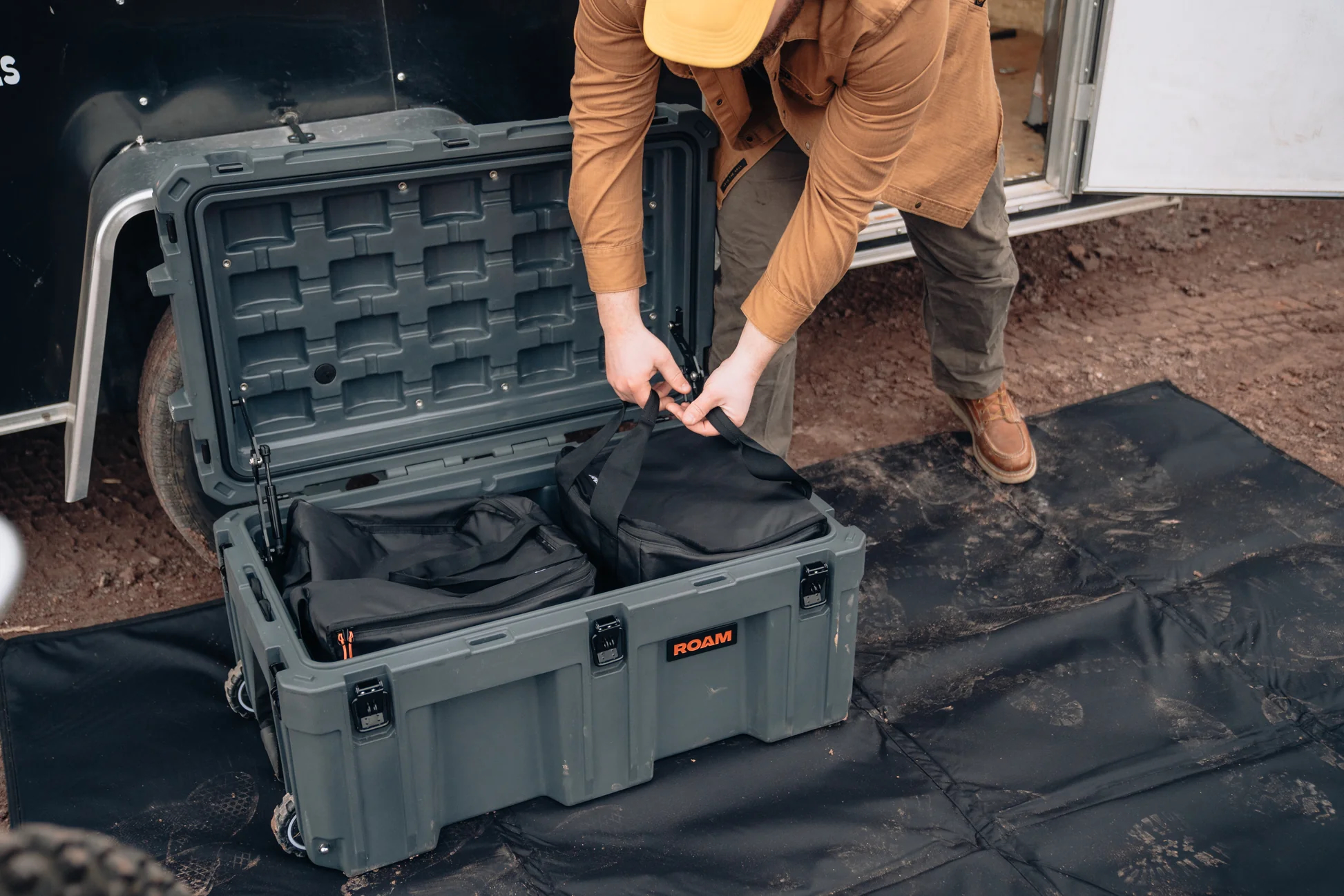 man grabbing camping bag out of case